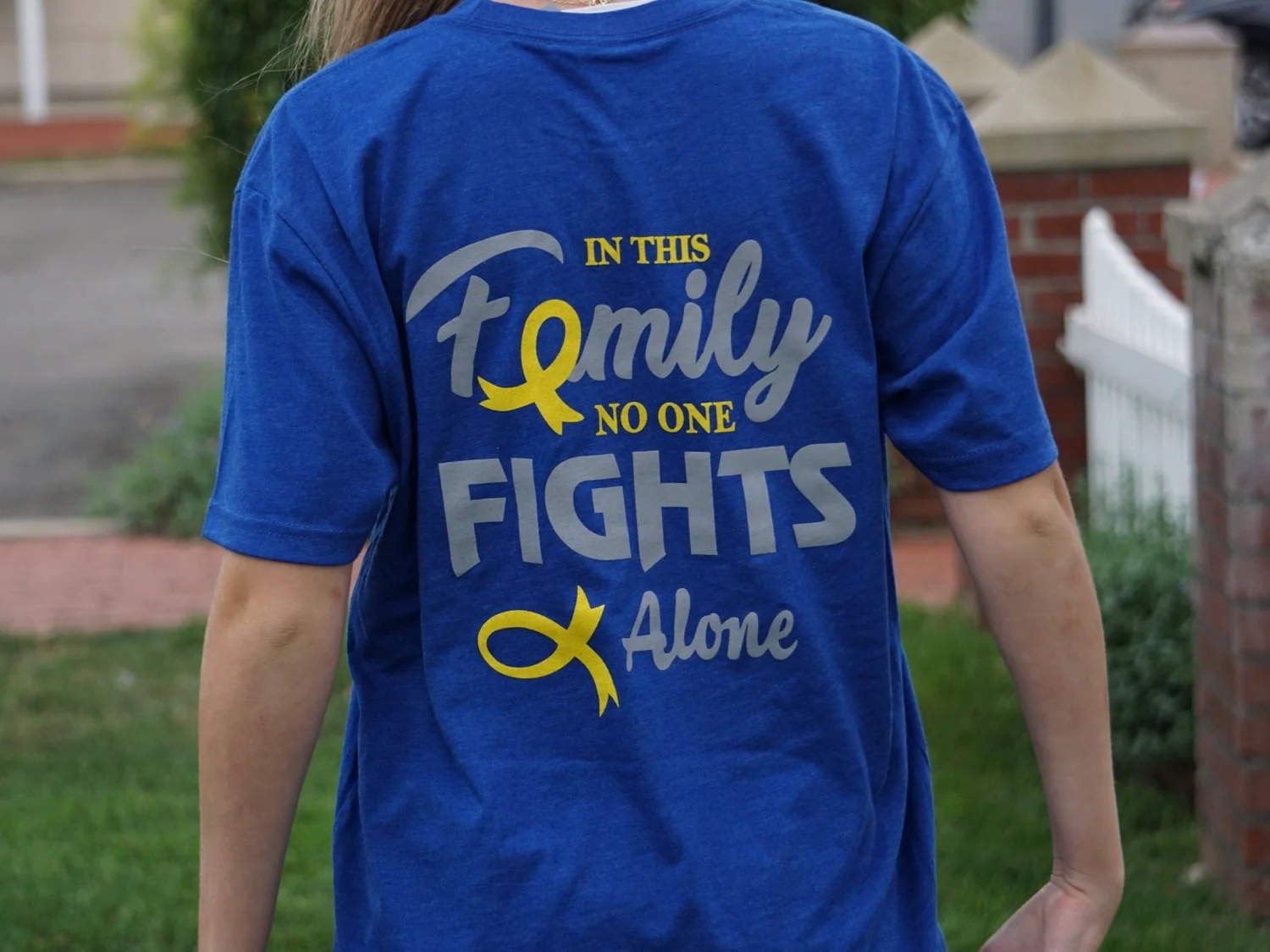 A Krusader wearing the In This Family No One Fights Alone shirt